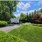 Restroom trailer surrounded by greenery and trees