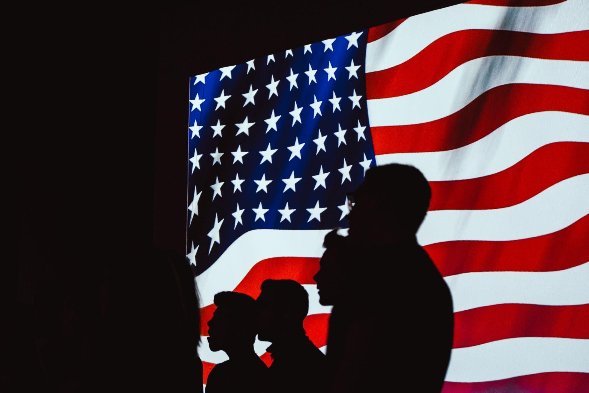 people in front of american flag