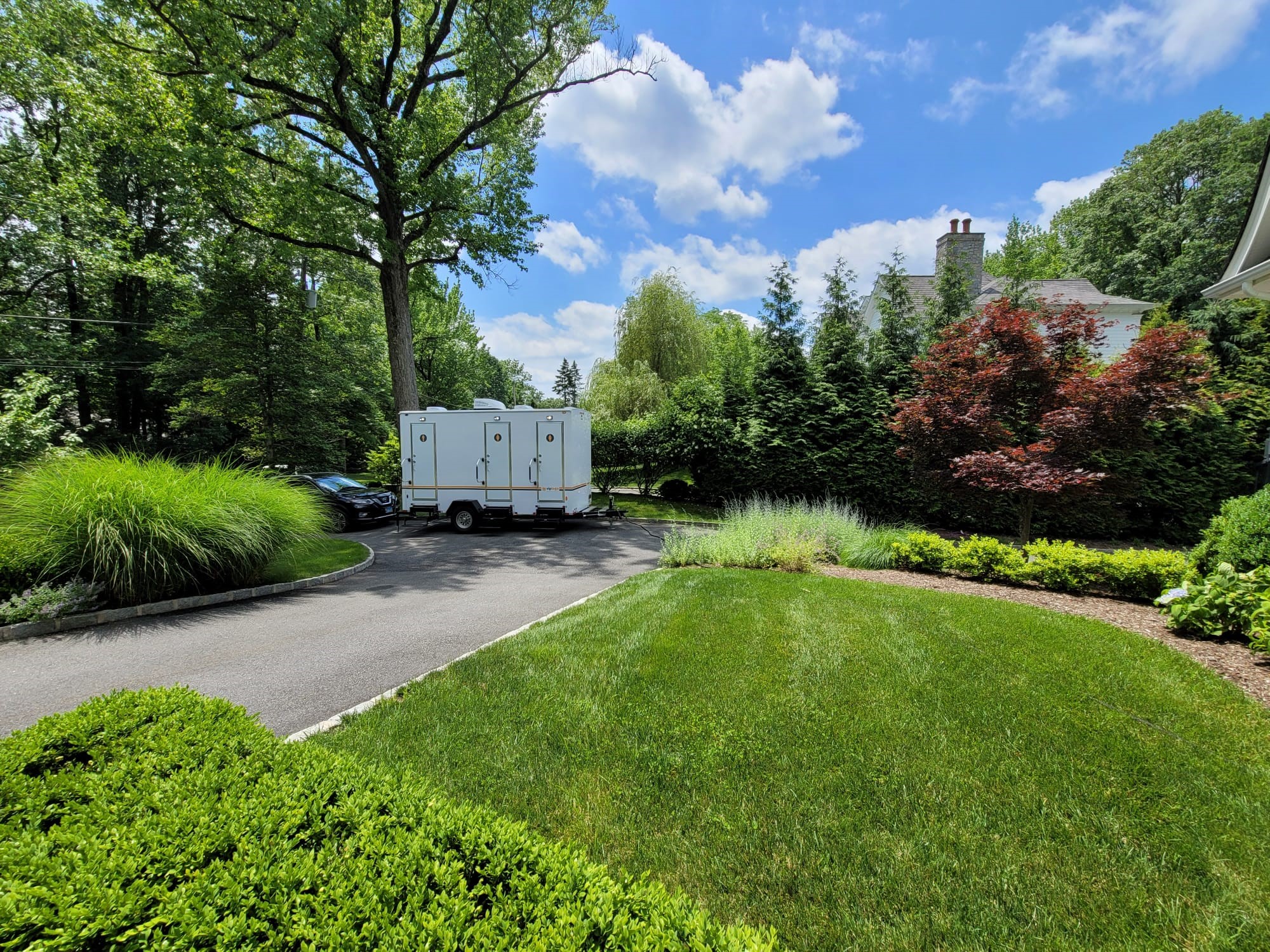 portable restroom trailer near landscaped property