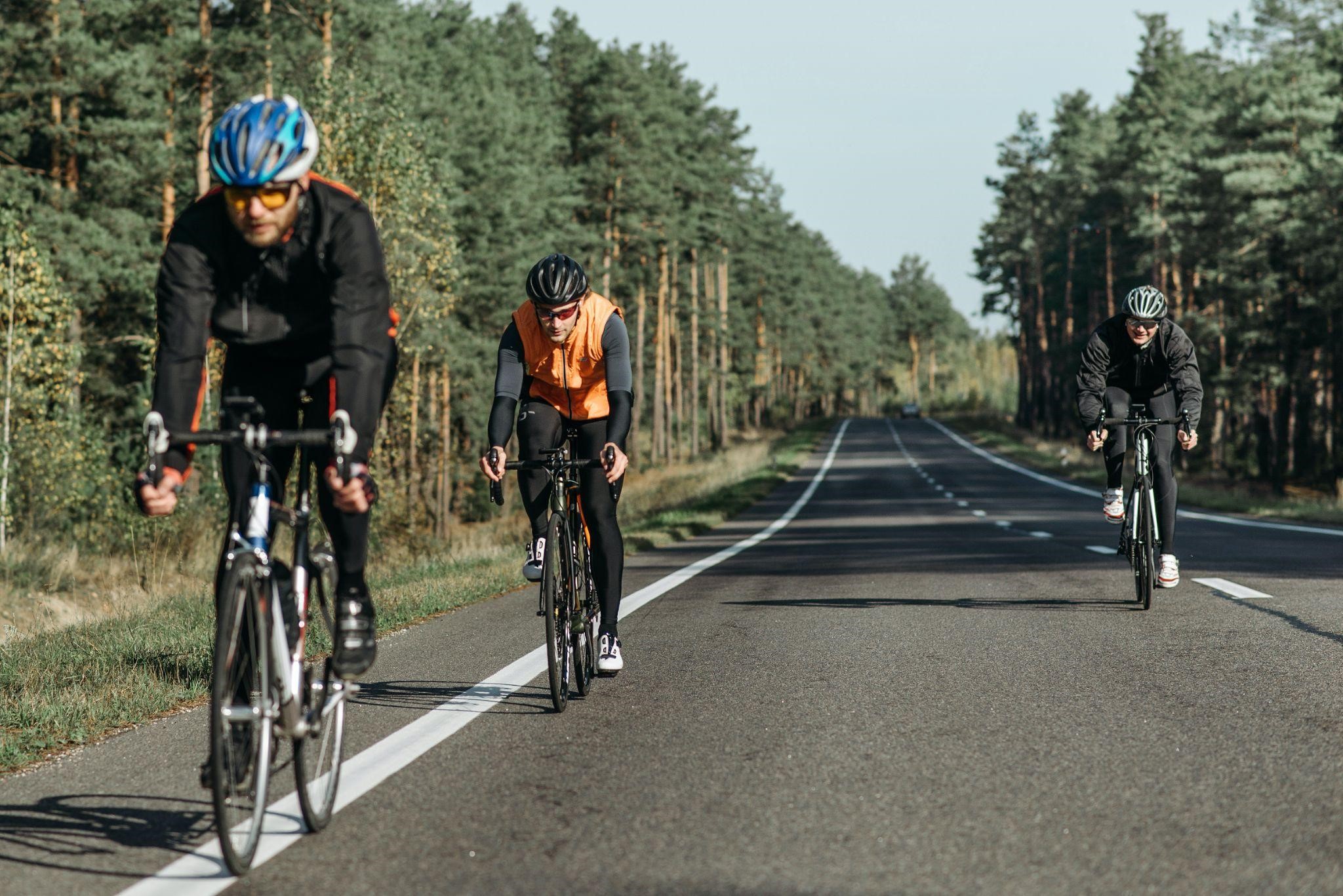 3 bikers riding on empty road