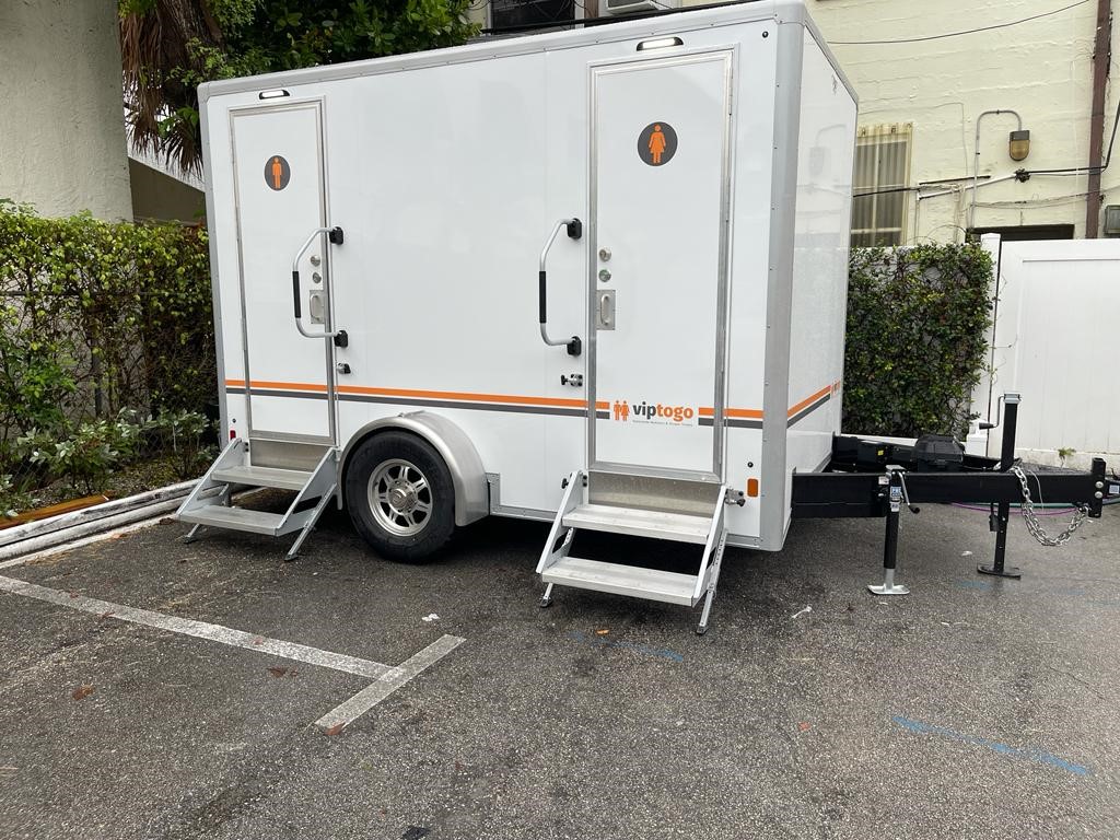 parked portable toilet trailer for event