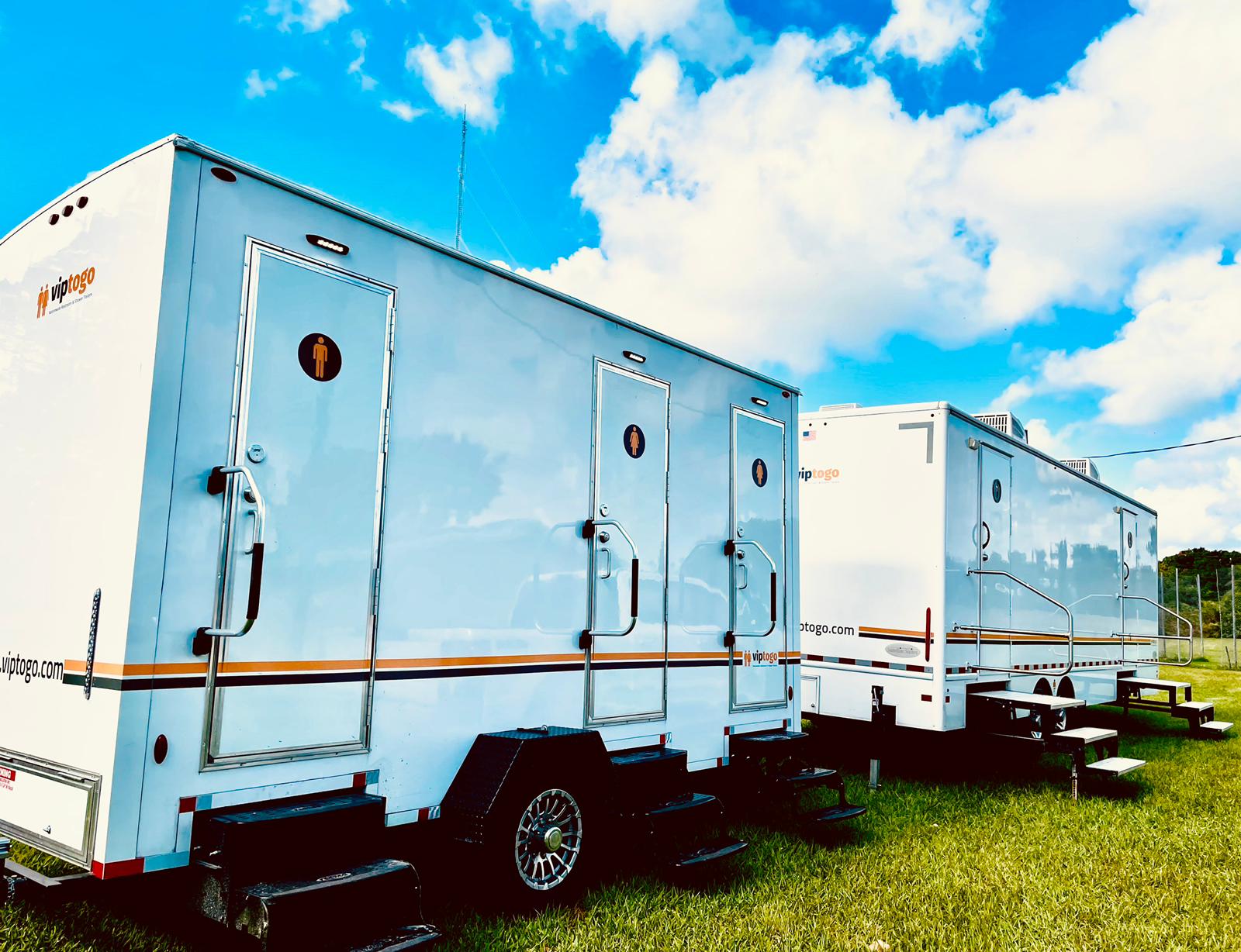 portable restroom trailers on grass