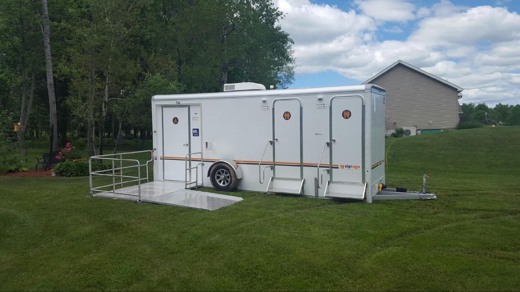 VIP portable bathroom unit parked on grass