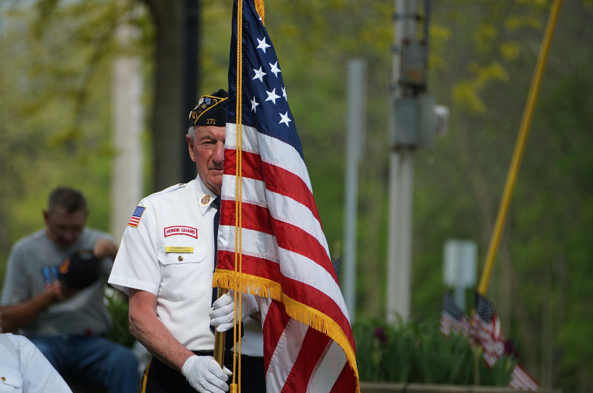 guard holding american flag